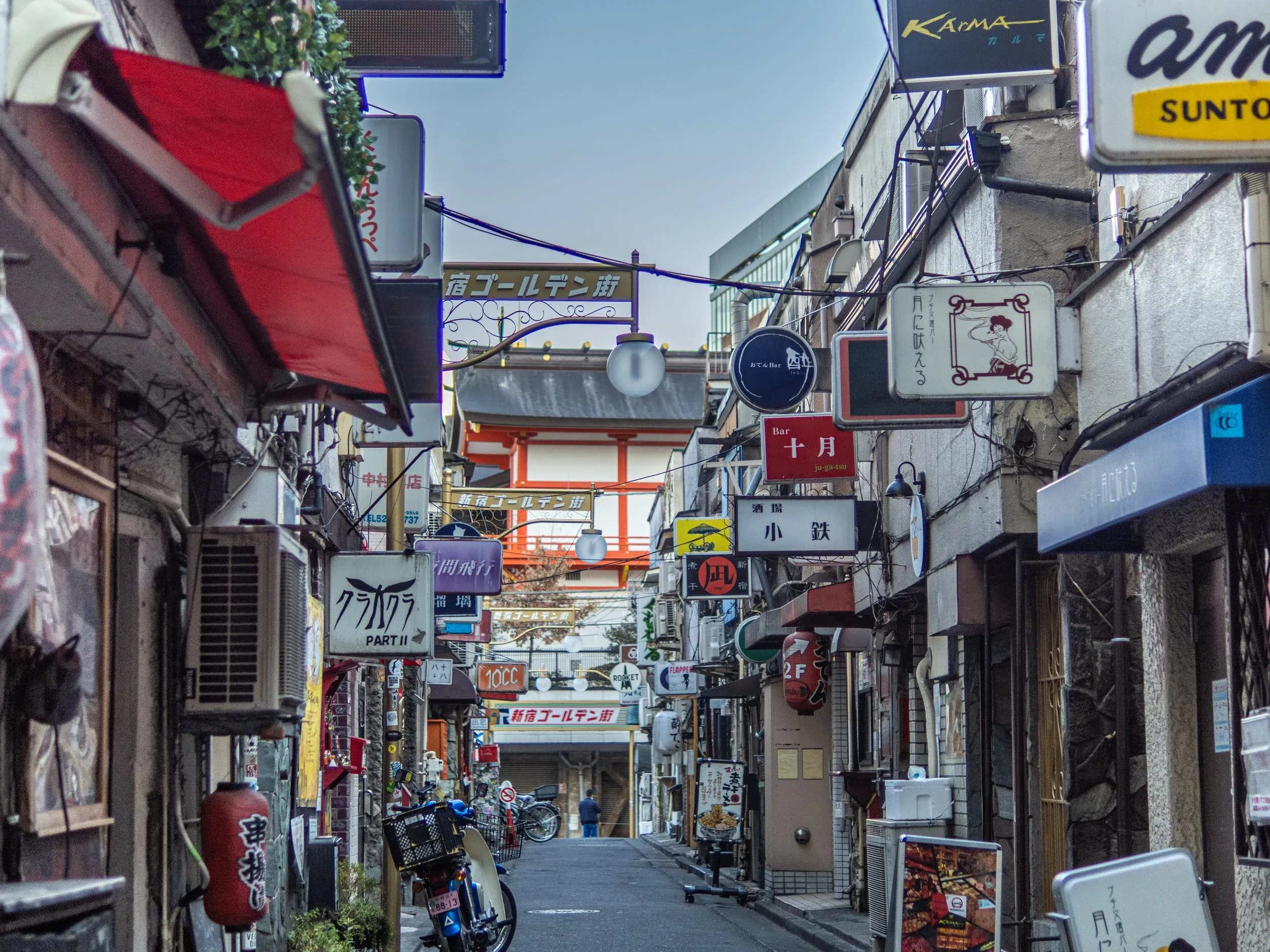 Popular claustrophobic nightlife district Golden Gai in Shinjuku, with 17th century Hanazono Shrine behind