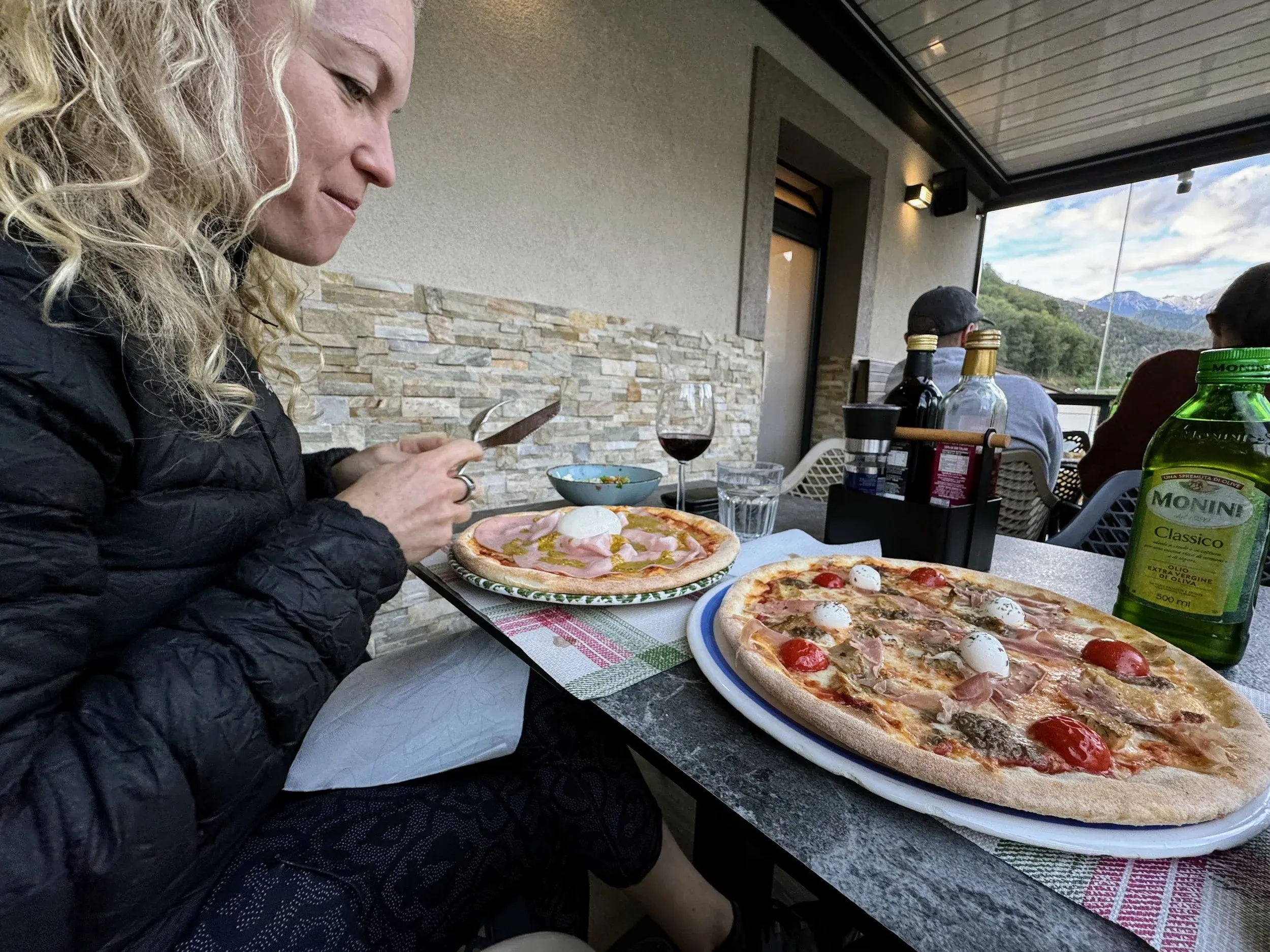 The perfect post ride dinner: local wine, pizza, accompanied by a giant bottle of olive oil and various vinegars